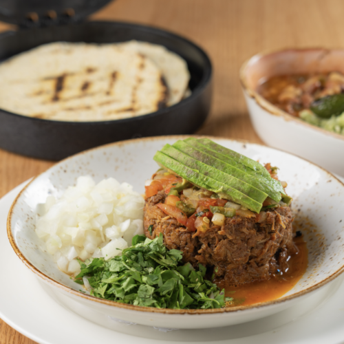 BARBACOA - Low and slow spiced beef short rib, adobo chili sauce, cilantro rice, Borracho beans, lots of onions, pico de gallo, fresh lime, cilantro pesto, warm tortillas